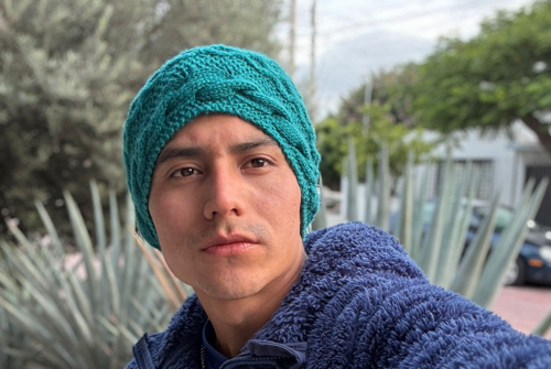 Young man wearing a blue knitted cap